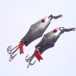 Plandav� t�pytka, zleva velikost 60 mm, v�ha 9,05 g a velikost 47 mm, v�ha 6,86 g. �tikov� a okounov� t�pytka vykrojen�ho tvaru, s �erven�m um�lohmotn�m o�kem, bez �upinek. Niklovan�. Nesignov�no. V�robce ZNAK HK.