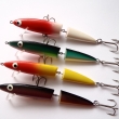 CORA, d�lka 110 mm, 12 g. Wobbler dvoud�ln�, montovan� s 2 trojh��ky. Plovouc�. V�robce J.M.B. RYNA. R�zn� dekory.